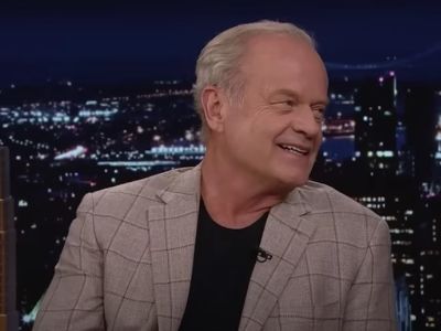 Kelsey Grammer is wearing a suit with black tee in the picture.